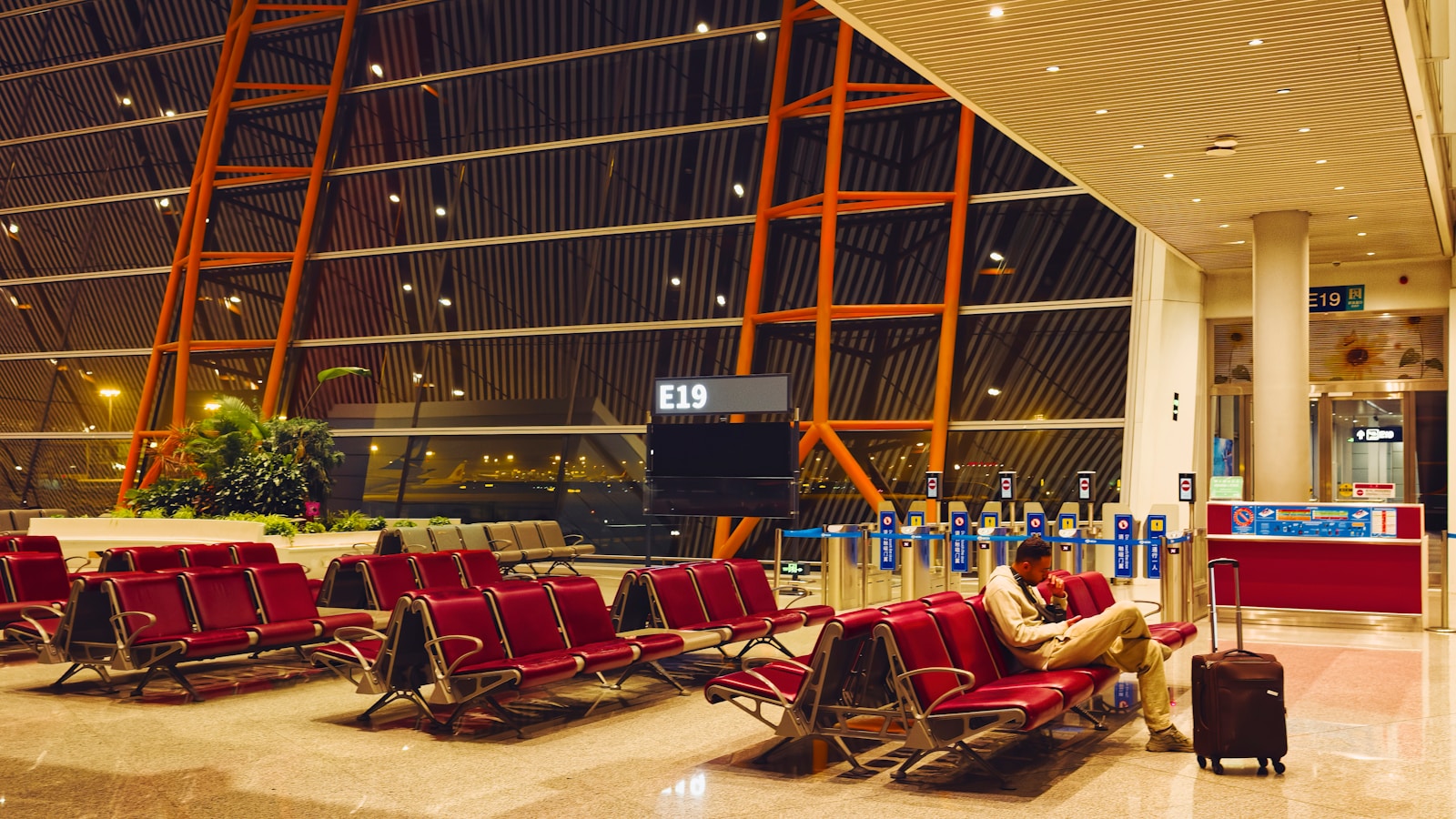Traveler waiting with luggage at an airport gate