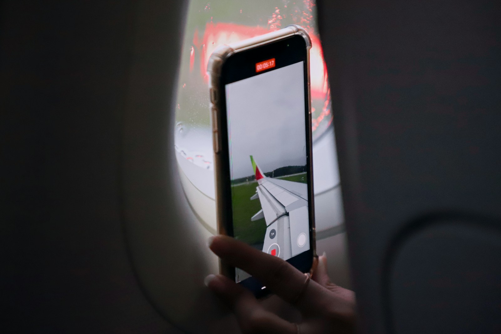Phone used near an airplane window before a trip