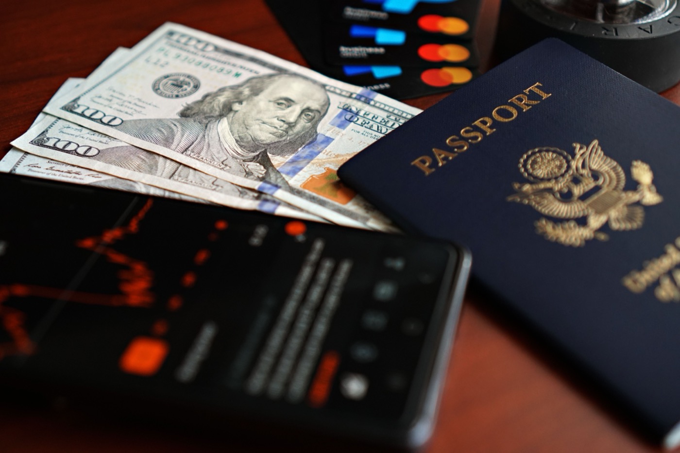 Passport, phone, cash, and cards prepared before an international trip